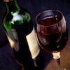 glass of red wine and bottle